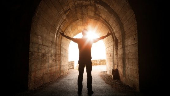 man stood in dark tunnel